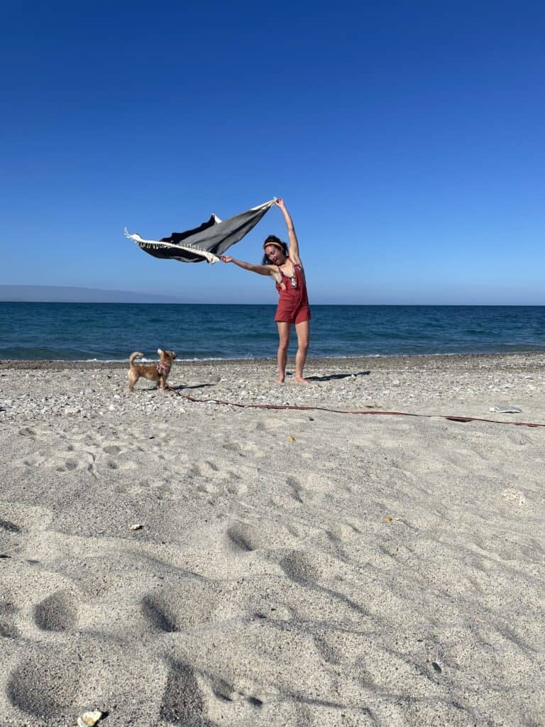 Small dog travel accessories: Sheila and I playing on the beach in south Italy with our travel blanket